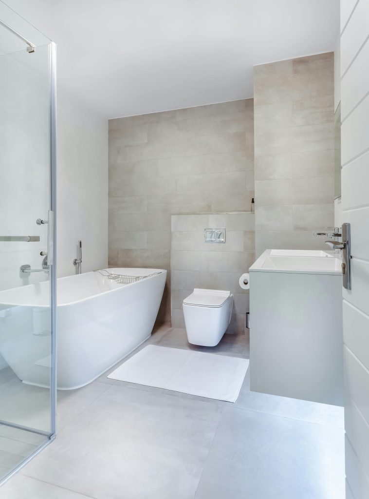 pexels-photo-1457847-1457847 Elegant minimalistic bathroom featuring bathtub and sleek fixtures.